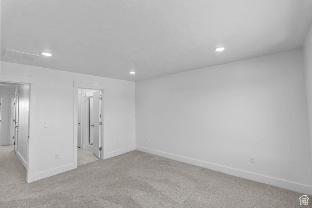 Unfurnished room featuring light colored carpet