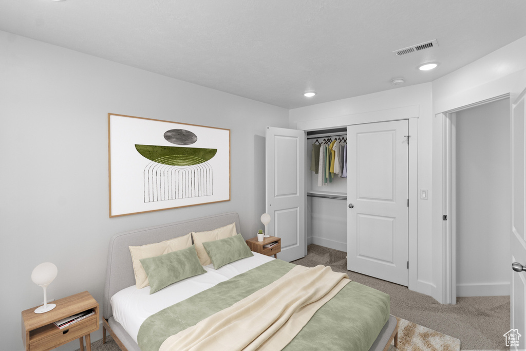 Carpeted bedroom featuring a closet