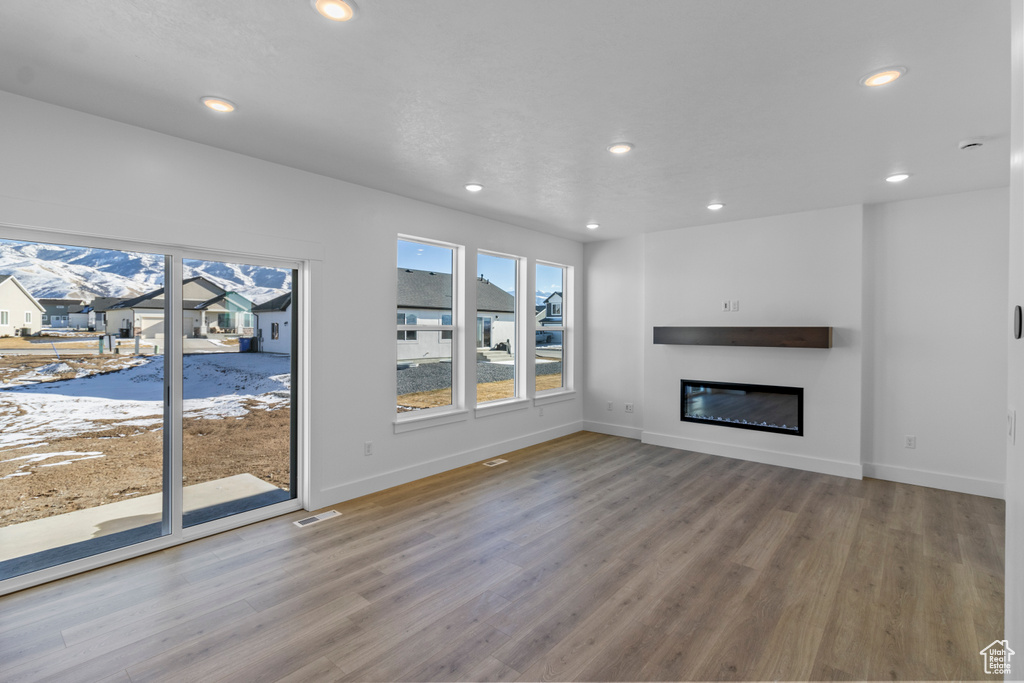 Unfurnished living room featuring wood-type flooring