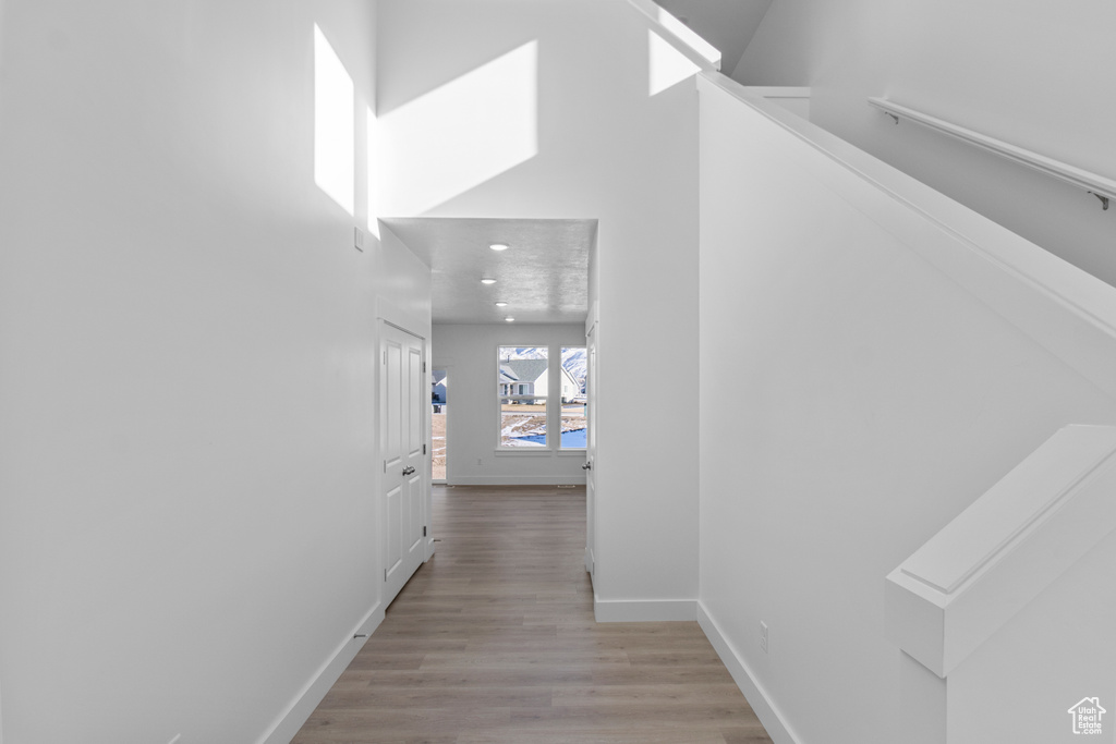 Corridor with light hardwood / wood-style floors