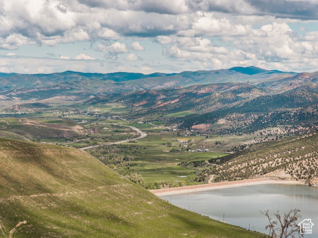 Property view of mountains featuring a water view