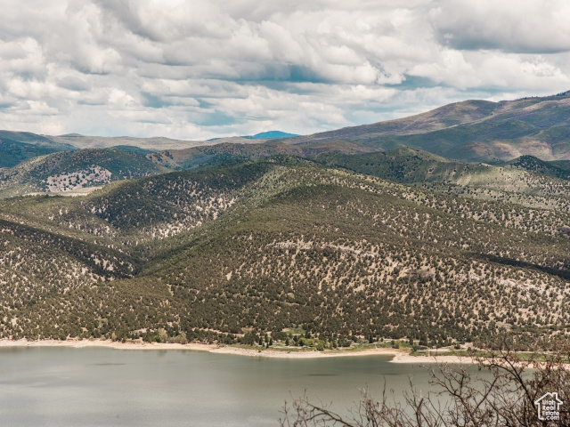 Property view of mountains featuring a water view