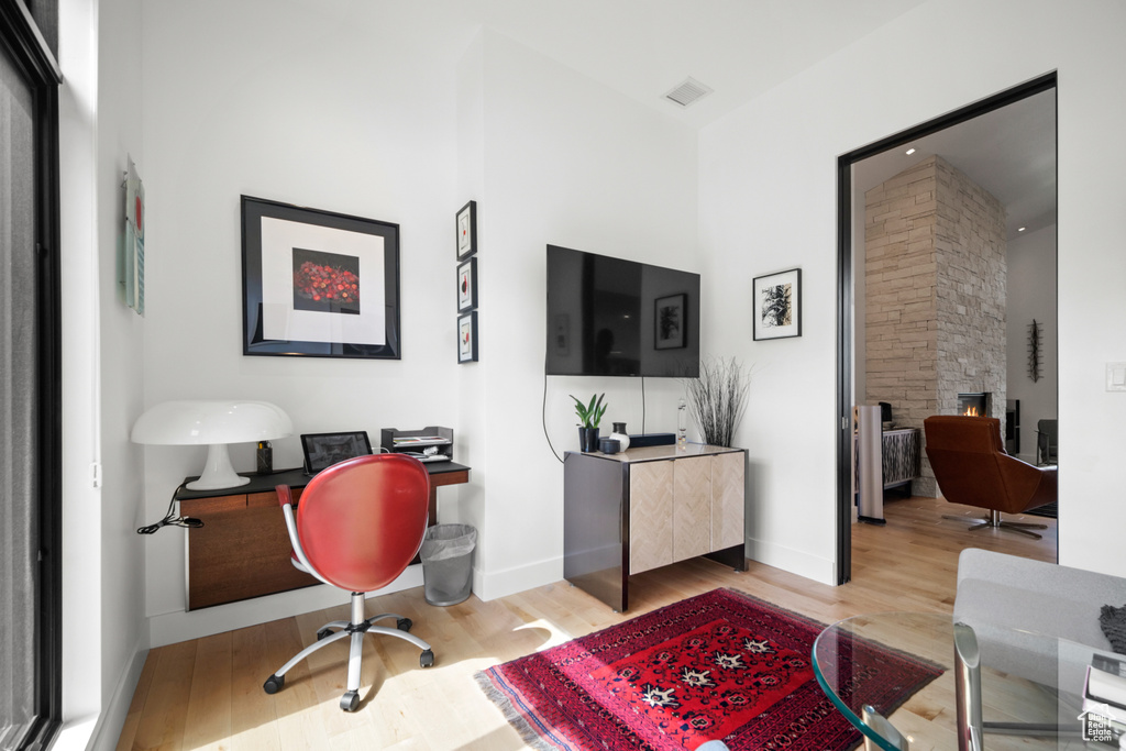 Office with light hardwood / wood-style flooring