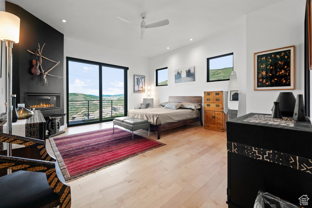 Bedroom with ceiling fan, access to outside, and light wood-type flooring