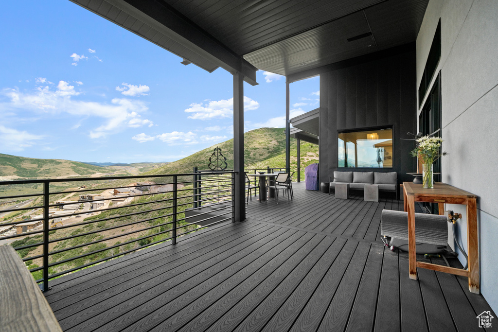 Wooden deck with a mountain view and an outdoor hangout area