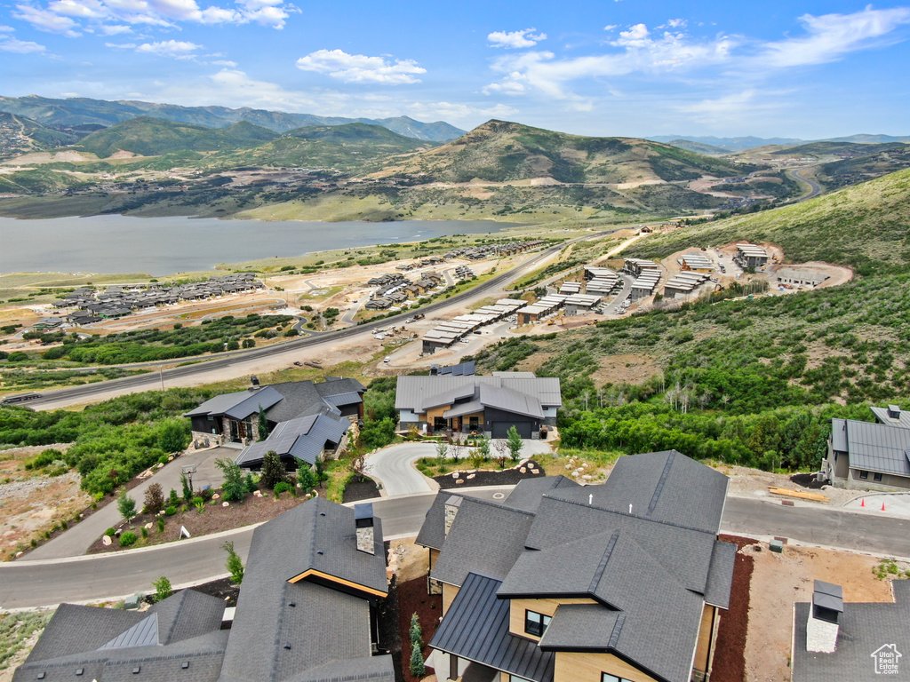 Drone / aerial view featuring a water and mountain view