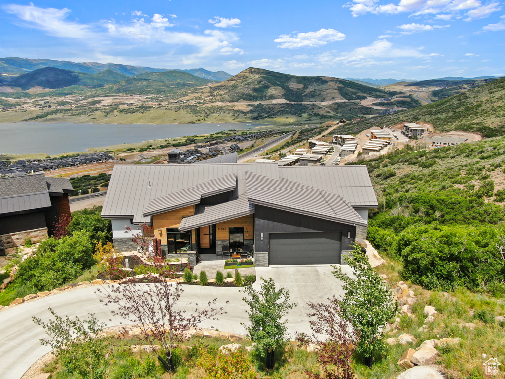 Exterior space with a water and mountain view