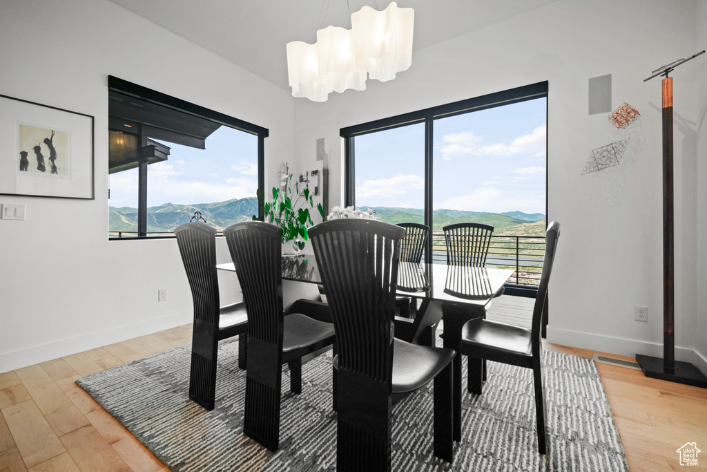 Dining space featuring an inviting chandelier, a mountain view, and hardwood / wood-style flooring