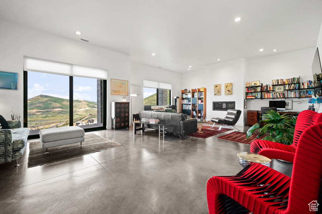 Living room with concrete flooring and a mountain view