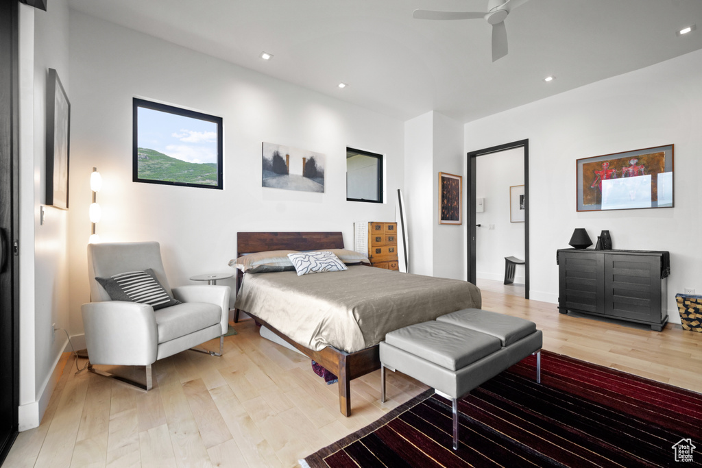 Bedroom with light hardwood / wood-style floors and ceiling fan