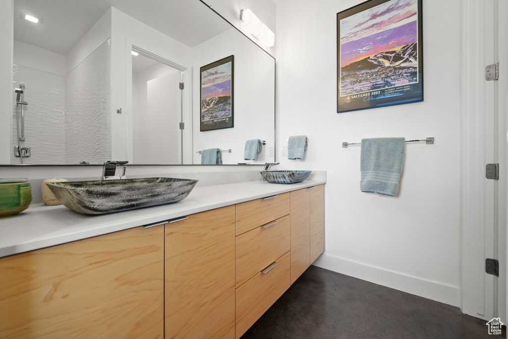 Bathroom with vanity and concrete flooring