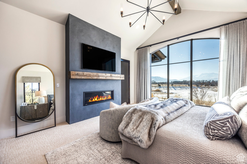 Bedroom featuring carpet, a chandelier, a fireplace, and access to outside