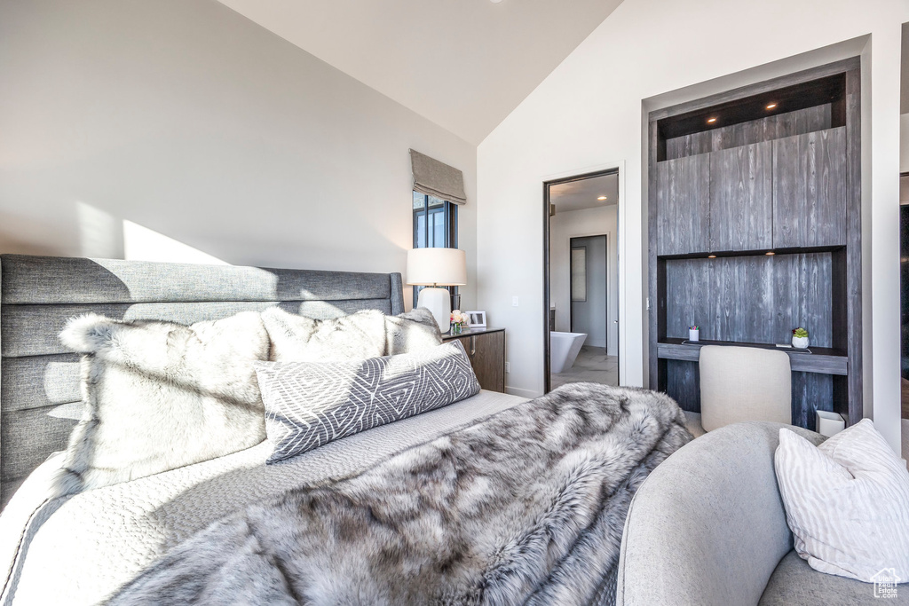 Bedroom featuring high vaulted ceiling and connected bathroom