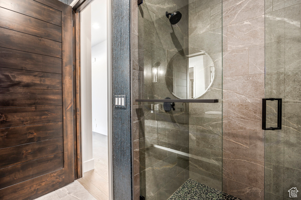 Full bathroom featuring a shower stall