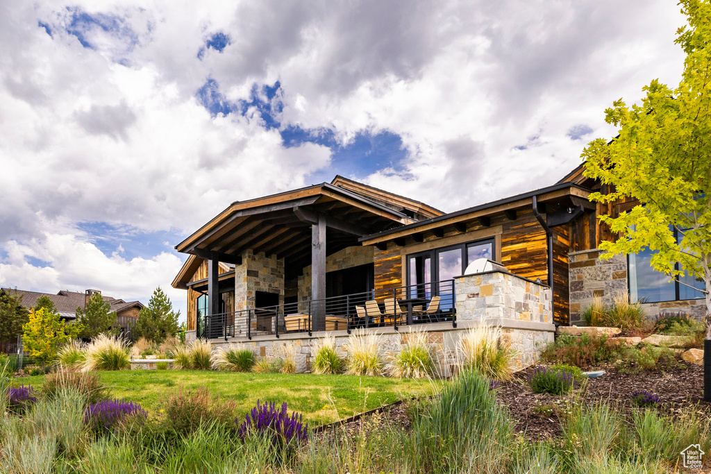 Rear view of house with stone siding