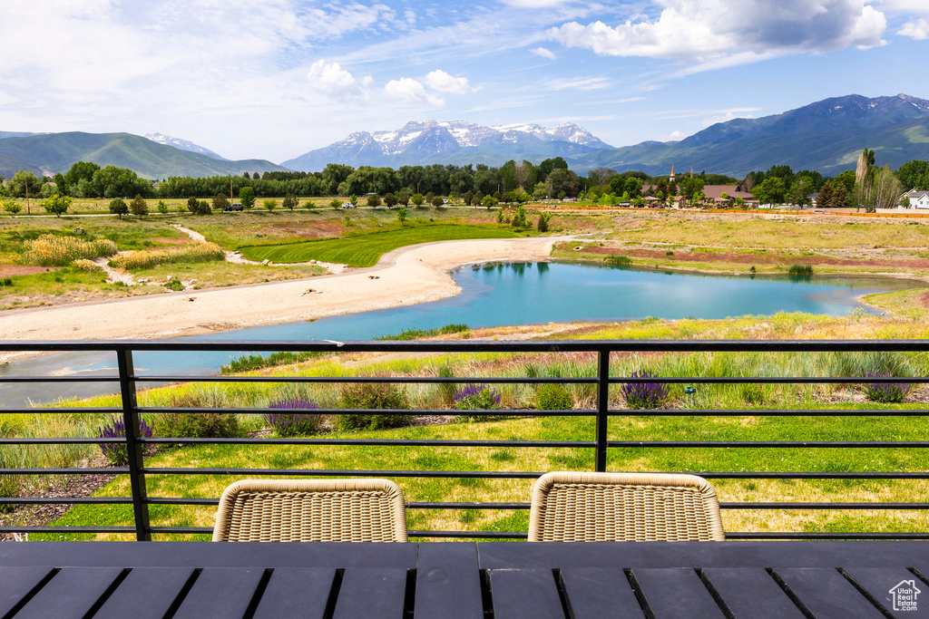 Balcony with a water and mountain view