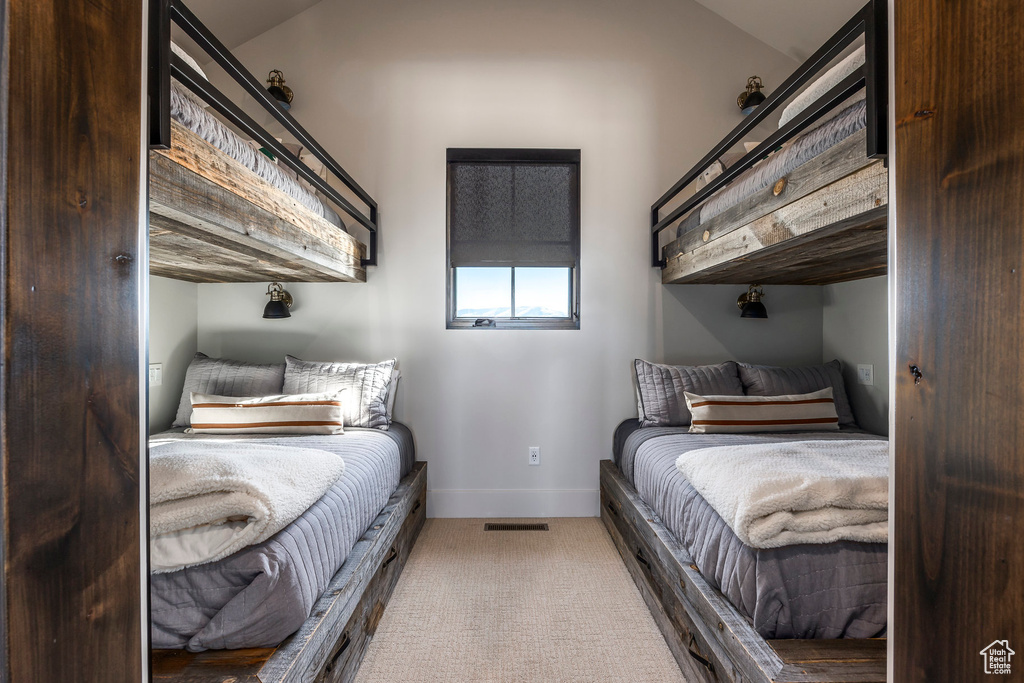 Bedroom featuring carpet floors and baseboards