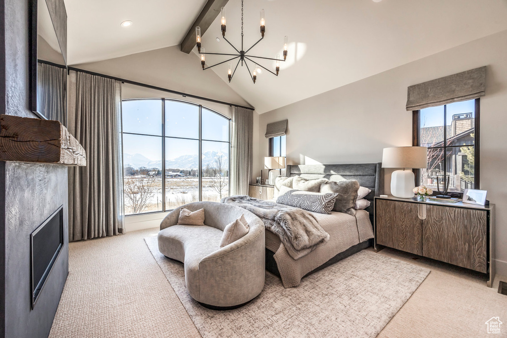Bedroom featuring a chandelier, light carpet, beamed ceiling, a mountain view, and high vaulted ceiling
