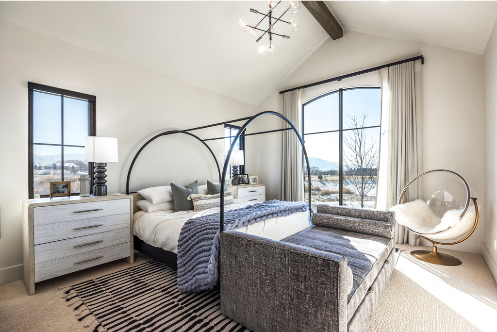 Bedroom featuring a mountain view, carpet floors, and a chandelier