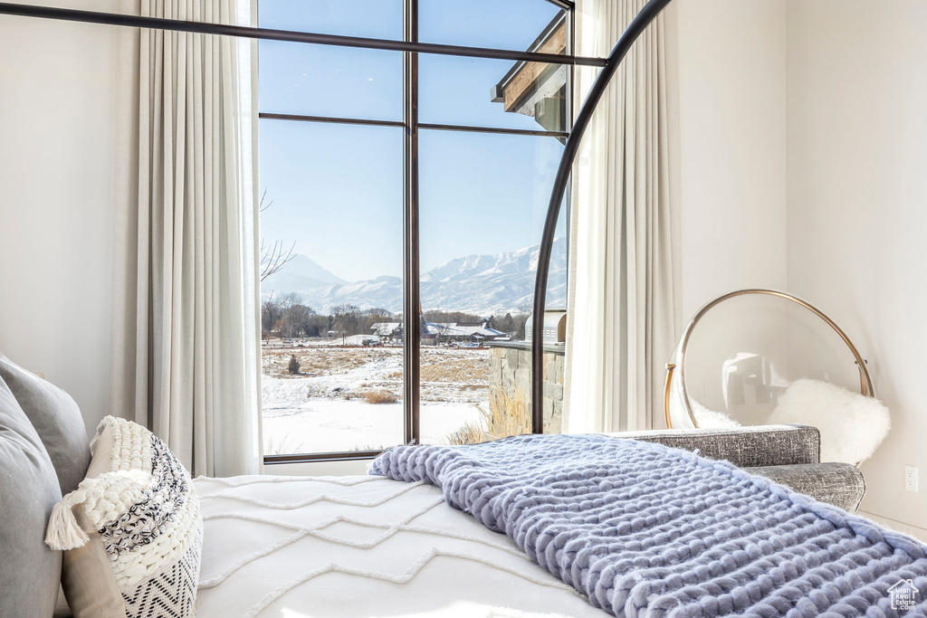 Bedroom with a mountain view and multiple windows