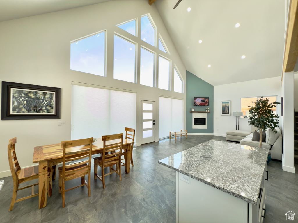 Dining area with beamed ceiling and high vaulted ceiling