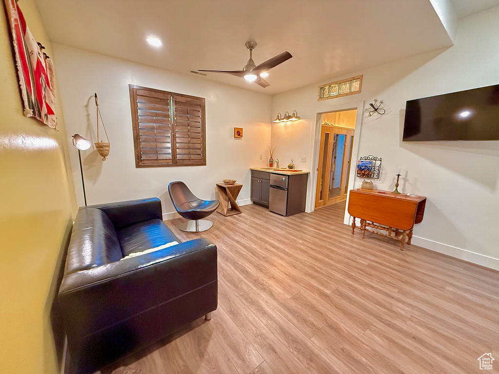 Living room featuring light hardwood / wood-style floors and ceiling fan