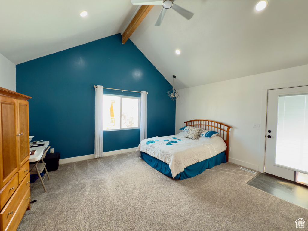 Carpeted bedroom featuring ceiling fan and vaulted ceiling with beams