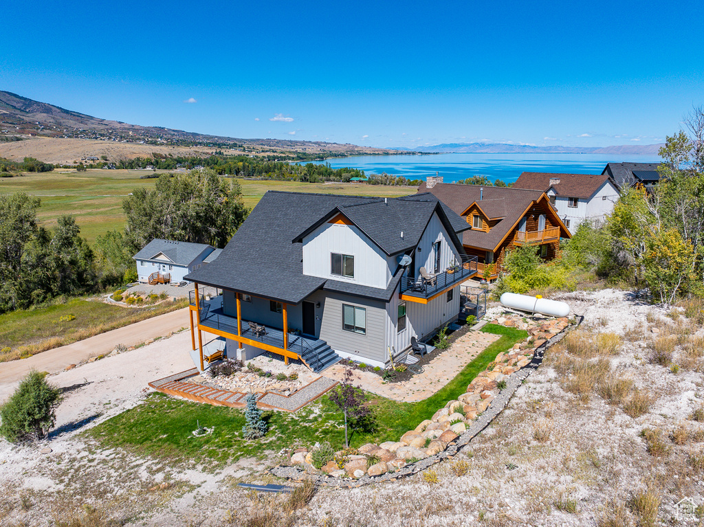 Drone / aerial view featuring a water and mountain view