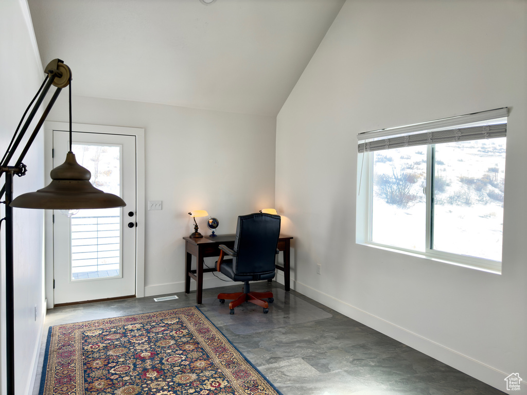 Office area featuring high vaulted ceiling