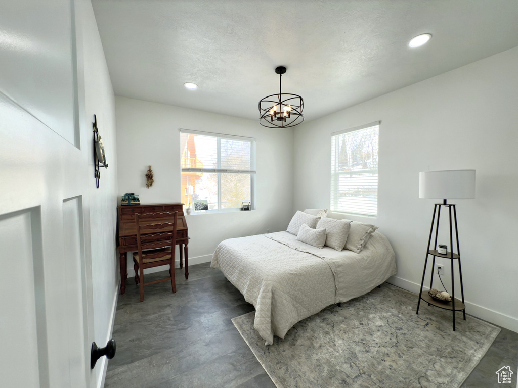 Bedroom featuring a notable chandelier