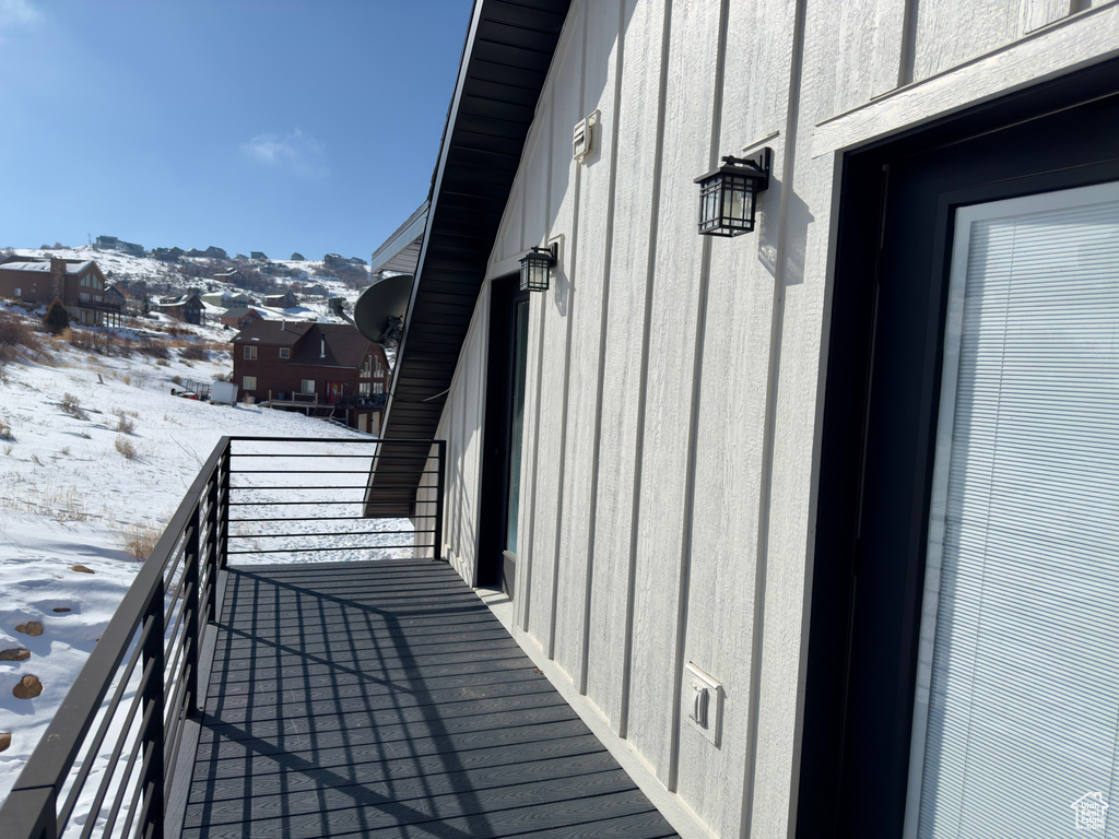 View of snow covered back of property