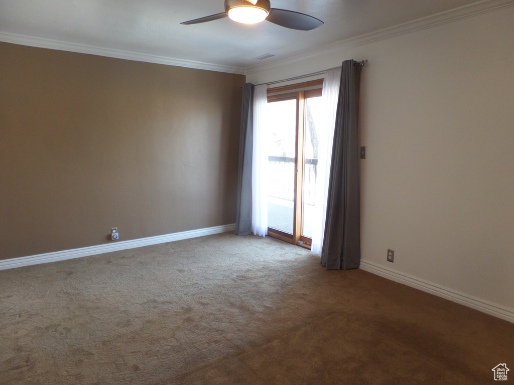 Unfurnished room with crown molding, carpet floors, and ceiling fan