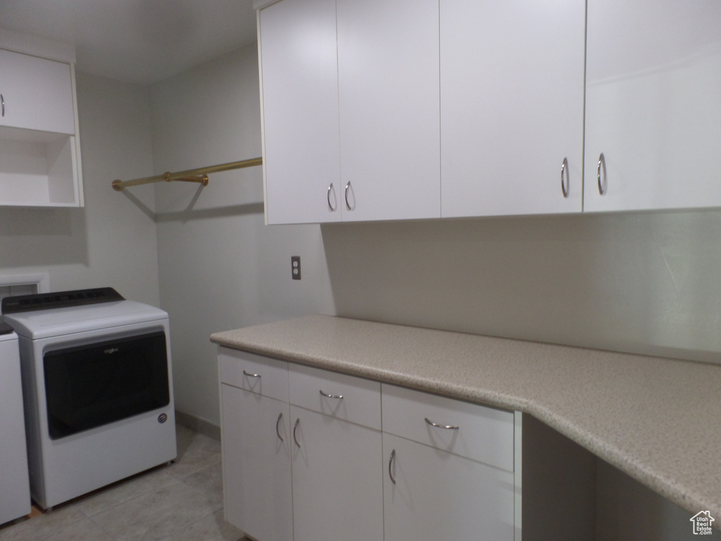 Laundry area featuring cabinets and washing machine and clothes dryer