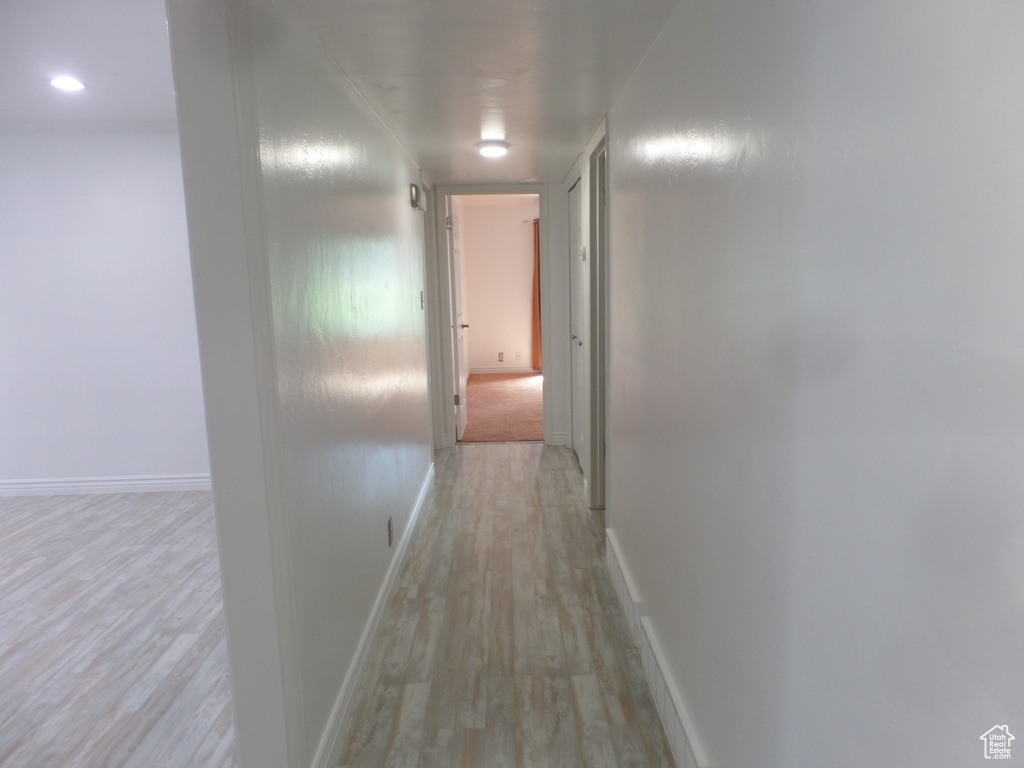 Hall featuring light wood-style floors and baseboards