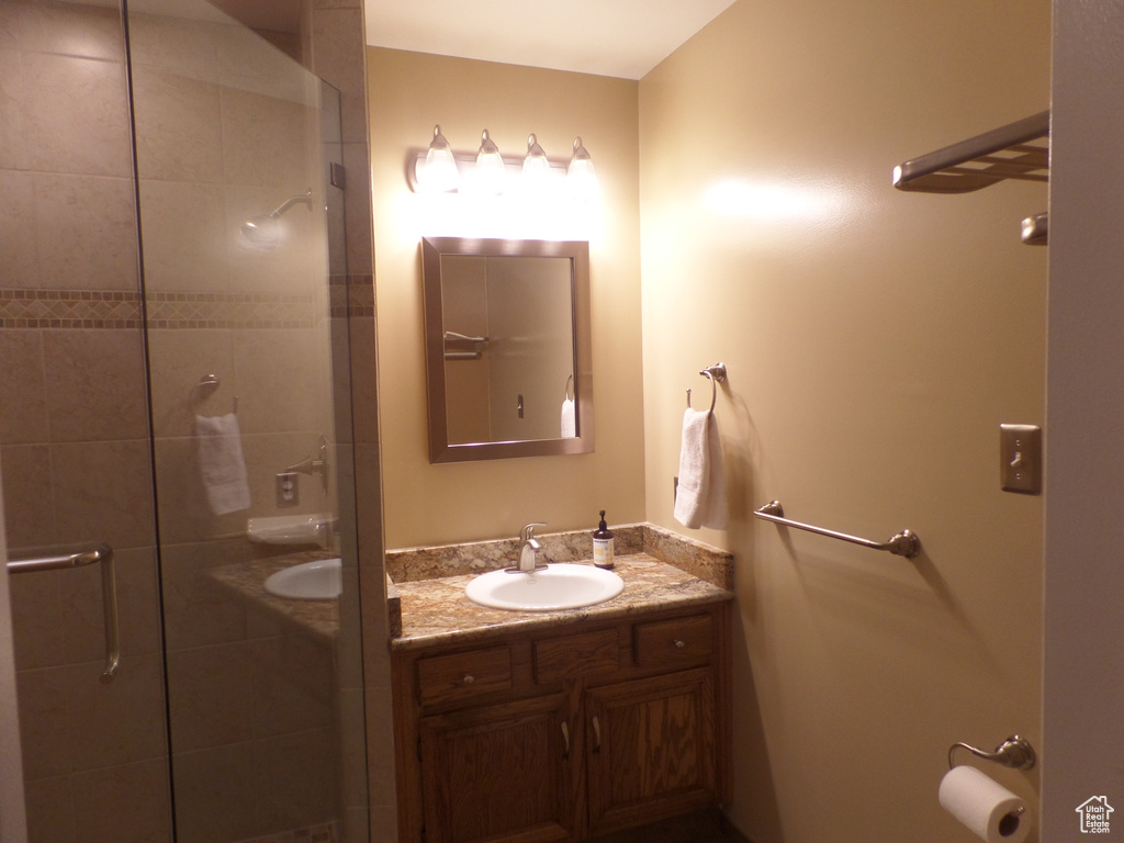 Bathroom with a shower with door and vanity