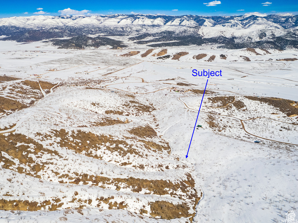 Snowy aerial view with a mountain view