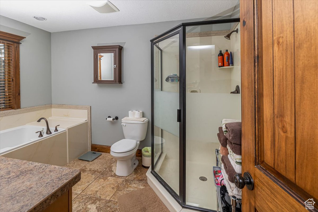 Bathroom featuring toilet and separate shower and tub