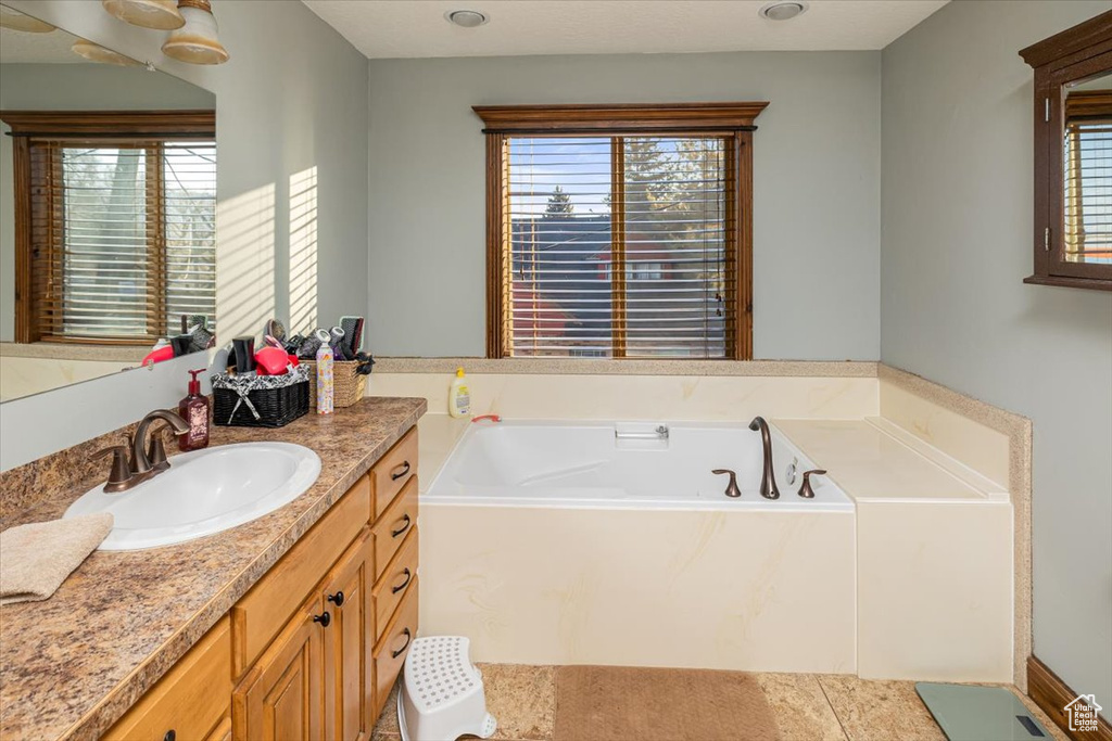 Bathroom with vanity and a tub to relax in