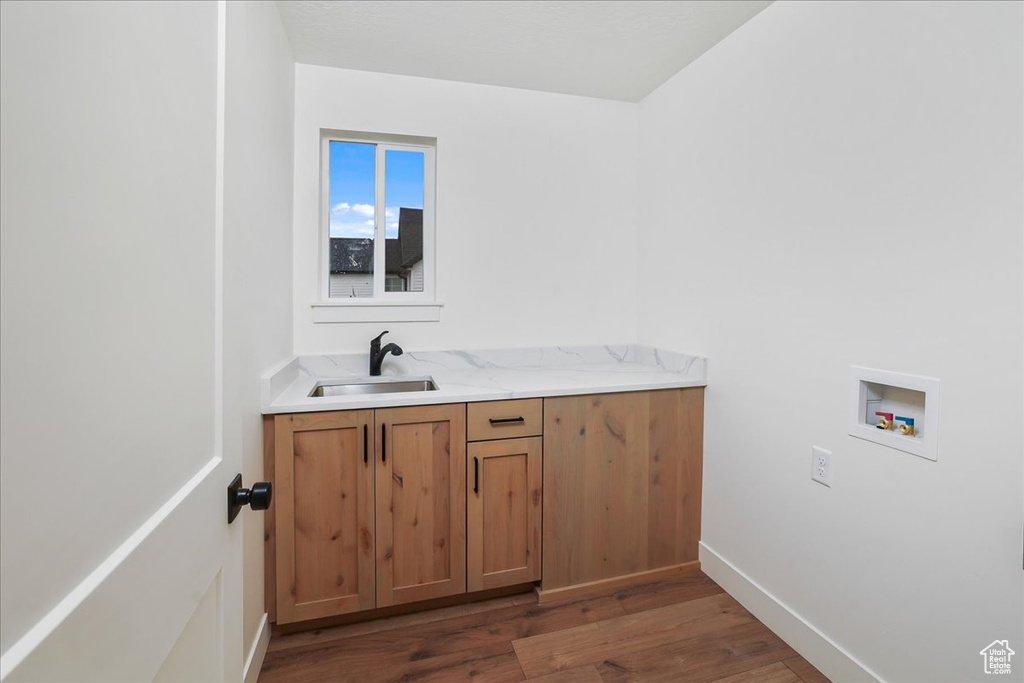 Bathroom featuring sink and wood-type flooring