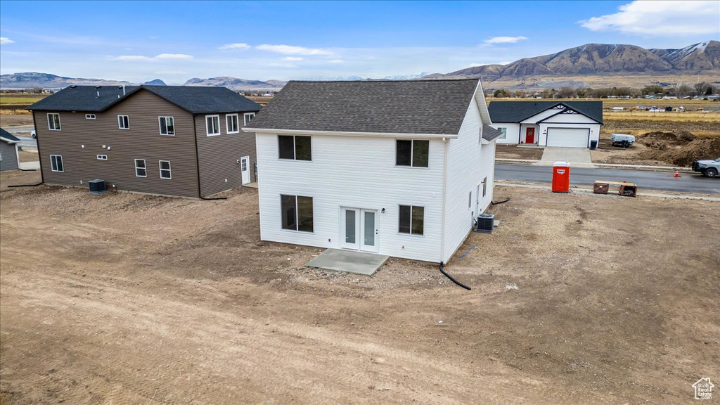 Back of property featuring cooling unit and a mountain view