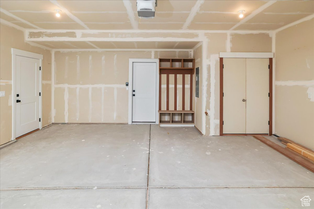 Garage featuring a garage door opener and electric panel