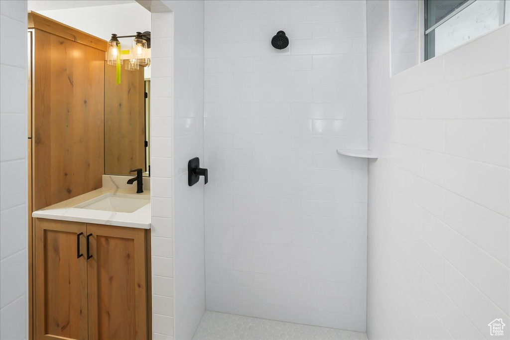 Bathroom with vanity and tiled shower