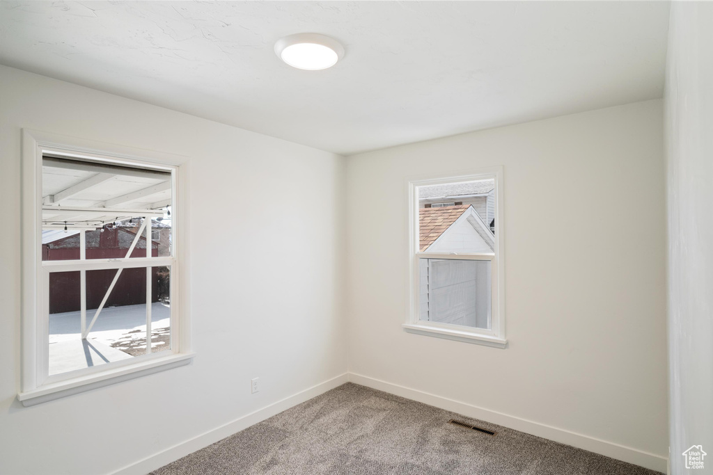 Unfurnished room featuring carpet flooring