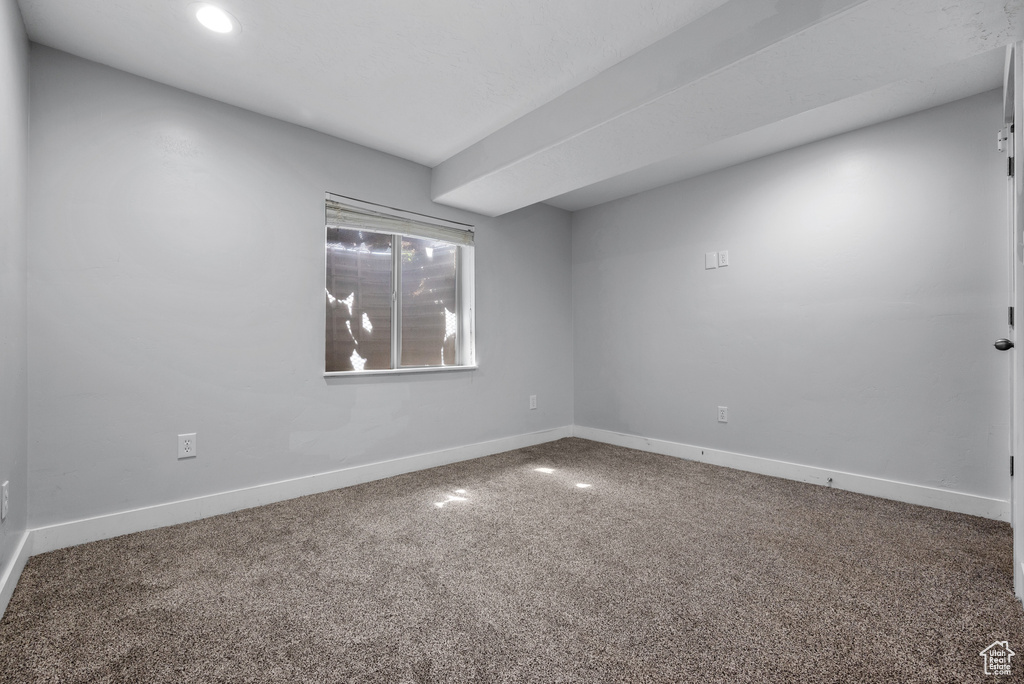 Carpeted empty room featuring baseboards and recessed lighting