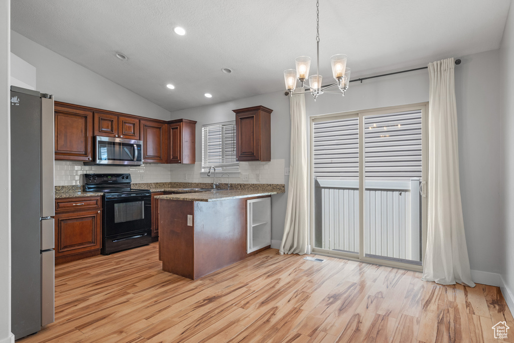 Kitchen with stainless steel appliances, backsplash, light wood-style floors, lofted ceiling, and recessed lighting