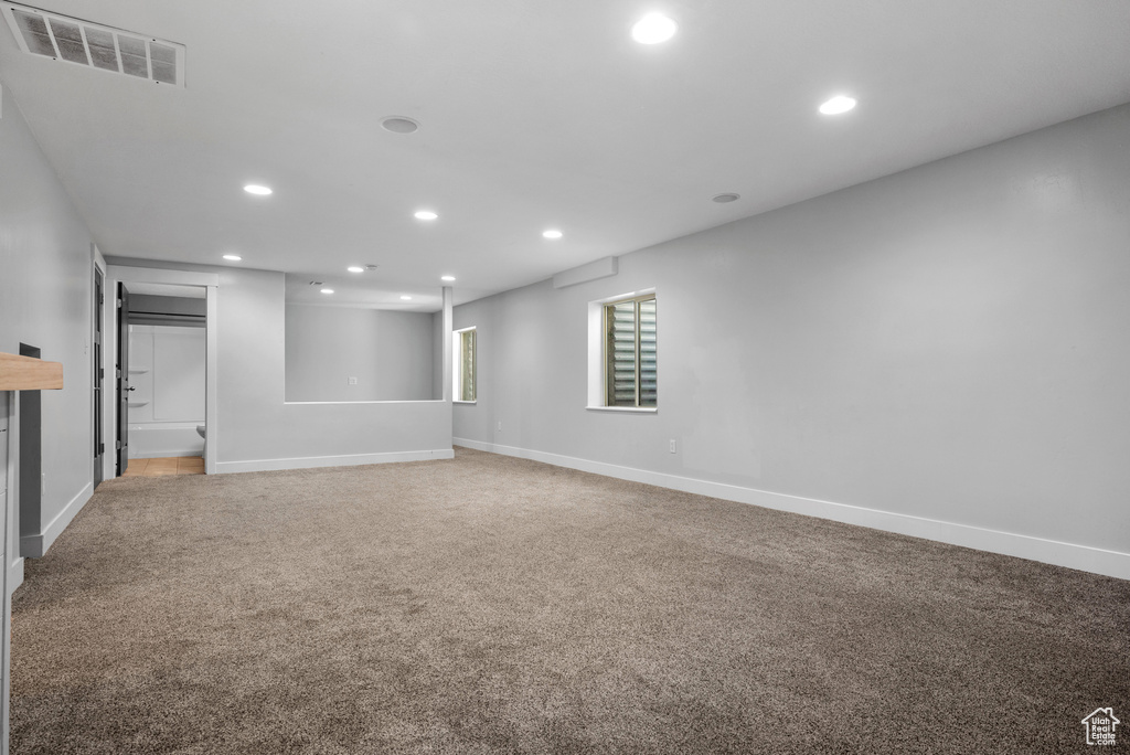 Unfurnished room with recessed lighting, light colored carpet, and baseboards