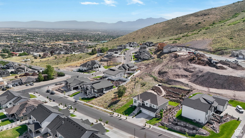 Aerial overview of property\'s location with nearby suburban area and a mountainous background