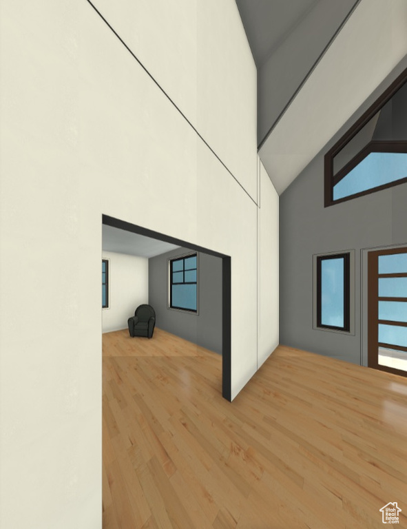 Bonus room featuring wood finished floors and high vaulted ceiling