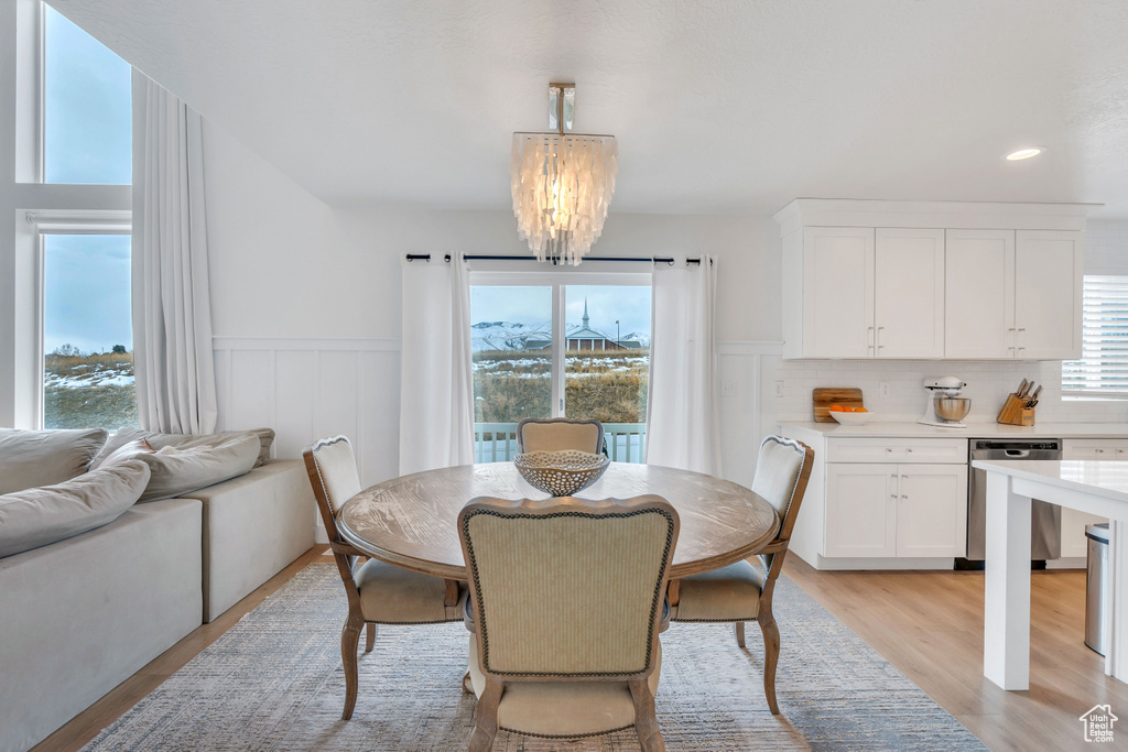 Dining area featuring a chandelier and light hardwood / wood-style floors