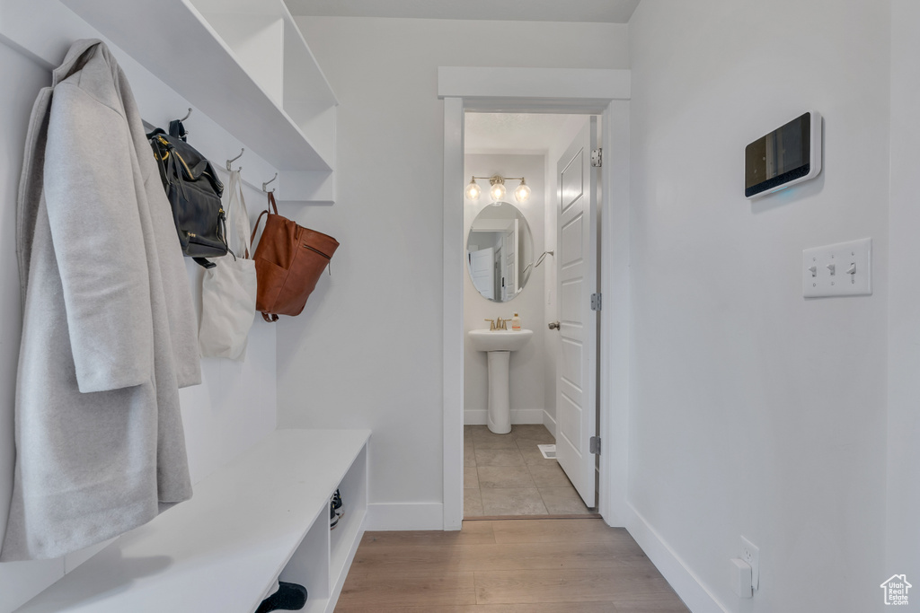 Mudroom with sink and light hardwood / wood-style floors